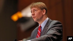 FILE - Consumer Financial Protection Bureau Director Richard Cordray, pictured in March 2015, says arbitration clauses in consumers' agreements with financial companies effectively deny groups "the right to seek justice and relief for wrongdoing."