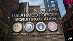 FILE - The Times Square military recruiting station displays insignia for each military branch in New York, July 15, 2015. President Donald Trump has called for a Space Force as a new military branch.