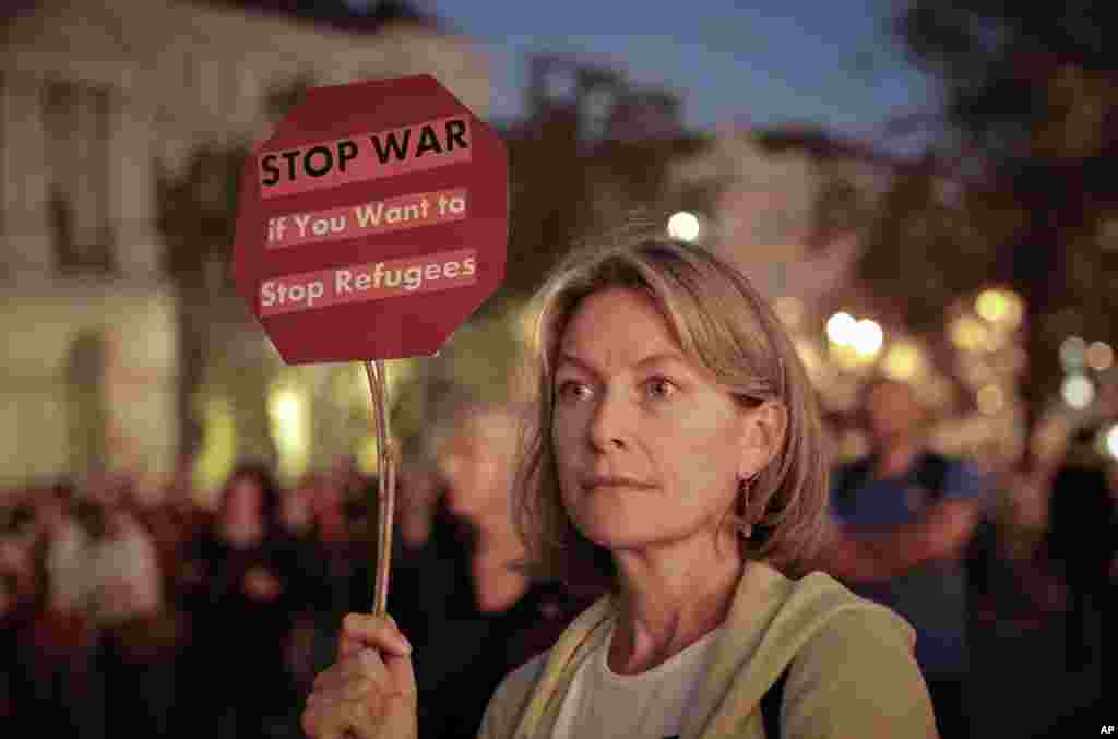 A woman holds a banner during a protest against Hungarian Premier Viktor Orban&#39;s policies regarding migrants in Budapest, Sept. 30, 2016.