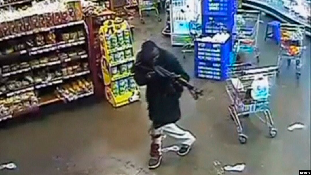FILE - A gunman aims his rifle inside a store during an attack on the Westgate shopping mall in this still frame taken from video footage by security cameras inside the mall in Nairobi and released to Reuters on Oct. 17, 2013.