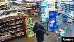 FILE - A gunman aims his rifle inside a store during an attack on the Westgate shopping mall, released to Reuters Oct. 17, 2013.
