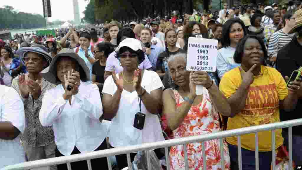 Three women who attended marches in the past, from left, Armanda Hawkins of Memphis, Vera Moore of Washington, and Betty Waller Gray of Richmond, Va., (holding sign) listen to the speakers during the March on Washington, Aug. 28, 2013, at the Lincoln Memorial.