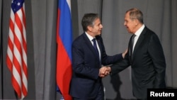 Russian Foreign Minister Sergei Lavrov shakes hands with U.S. Secretary of State Antony Blinken during a meeting on the sidelines of the OSCE Ministerial Council in Stockholm, Sweden, December 2, 2021. 