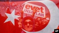 Supporters wait for the arrival of Turkey's President Recep Tayyip Erdogan for a last referendum rally in Istanbul, Saturday, April 15, 2017. 