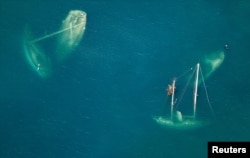 Vessels that sank during Hurricane Irma are seen in a Saint John bay 12 days after the devastating storm raked the island, on St. John, U.S. Virgin Islands Sept. 16, 2017.
