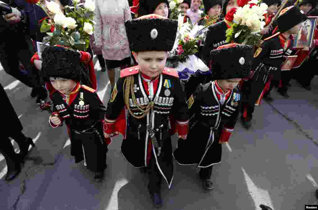 Children take part in a religious procession to mark the Palm Sunday in St. Petersburg, Russia.