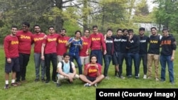 Members of Cornell University's Alpha Lambda Mu fraternity gather for an end-of- school year barbecue at the college's New York campus.