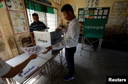 Election workers assemble a polling booth inside a classroom at a school in Phnom Penh, Cambodia, July 28, 2018.