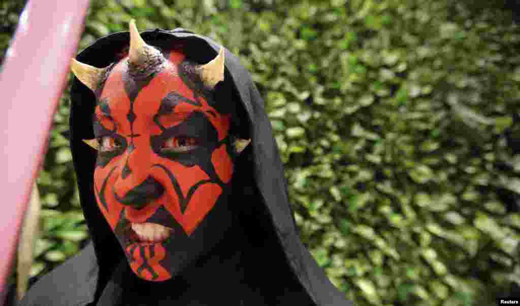 A woman dressed as the character Darth Maul attends the rollout of products in advance of the film &quot;Star Wars: The Force Awakens&quot; on &quot;Force Friday&quot; in Sao Paulo, Brazil. New &quot;Star Wars&quot; toys and other merchandise were released in stores across Sao Paulo during a global rollout of the popular products.