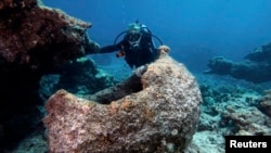 FILE - Maritime archaeologist Kelly Gleason with the Papahanaumokuakea Marine National Monument.