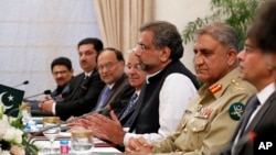 FILE - Pakistani Prime Minister Shahid Khan Abbasi, (3rd-R) speaks during his meeting with U.S.Secretary of State Rex Tillerson meeting at the Prime Minister's residence, Oct. 24, 2017, in Islamabad, Pakistan.