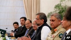 FILE - Pakistani Prime Minister Shahid Khan Abbasi, third right, speaks during a meeting at the Prime Minister's residence, Tuesday, Oct. 24, 2017, in Islamabad, Pakistan.