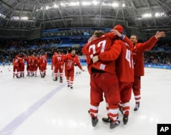 Olympic athletes from Russia celebrate after winning the men's gold medal hockey game against Germany, 4-3, in overtime at the 2018 Winter Olympics, Feb. 25, 2018, in Gangneung, South Korea.