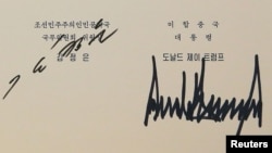 A document signed by U.S. President Donald Trump and North Korea's leader Kim Jong Un is seen in Singapore in this picture released on June 12, 2018 by North Korea's Korean Central News Agency.