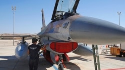 A mechanic from Israeli air force inspects an F-16 during the "Blue Flag" multinational air defense exercise at the Ovda air force base, north of the Israeli city of Eilat, on Oct. 24, 2021.