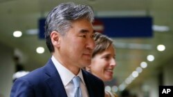 FILE - New U.S. Ambassador to the Philippines Sung Kim is escorted to the dignitaries lounge upon his arrival Dec. 1, 2016, at the Ninoy Aquino International Airport in suburban Pasay city south of Manila, Philippines.