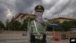 资料照：中国武警士兵做出禁止给北京人大会堂拍照的手式 。（2020年5月25日）