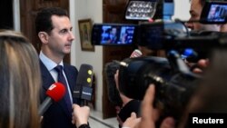 Syria's President Bashar al-Assad speaks to French journalists in Damascus, Syria, Jan. 9, 2017.