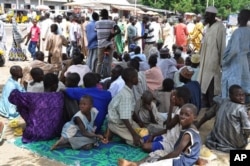 Civilians who fled their homes following an attacked by Islamist militants in Bama, take refuge at a School in Maiduguri, Sept. 3, 2014.