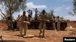 Free Syrian Army fighters prepare their ammunition during what they said was an offensive against forces loyal to Syria's President Bashar al-Assad in the southern city of Dara'a, June 25, 2015. 