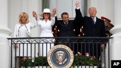 President Donald Trump, French President Emmanuel Macron, first lady Melania Trump and Brigitte Macron hold hands on the White House balcony during a State Arrival Ceremony at the White House in Washington, April 24, 2018. 