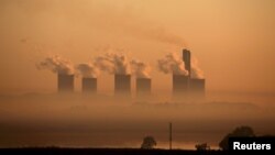 FILE - Steam rises at sunrise from the Lethabo Power Station, a coal-fired power station owned by state power utility ESKOM near Sasolburg, South Africa, March 2, 2016. 