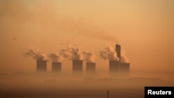 FILE - Steam rises at sunrise from the Lethabo Power Station, a coal-fired power station owned by state power utility ESKOM near Sasolburg, South Africa, March 2, 2016. 