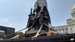 The Satanic Temple unveils its statue of Baphomet, a winged-goat creature, at a rally for the First Amendment in Little Rock, Ark., Aug. 16, 2018.