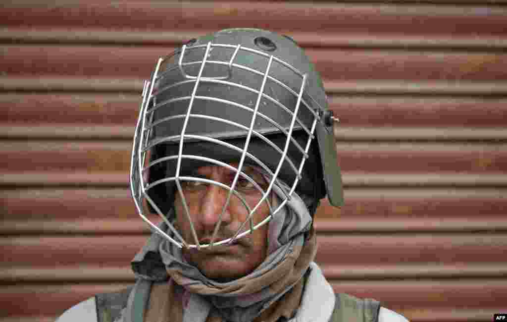 An Indian paramilitary trooper stands guard in Srinagar.
