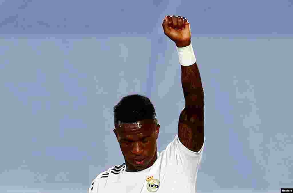 Real Madrid&#39;s Vinicius Junior celebrates scoring their first goal against Real Mallorca with a raised fist, as play resumes behind closed doors in Madrid, Spain.