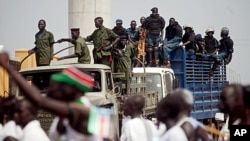 Southern Sudanese security forces watch over an independence rehearsal procession in Juba, South Sudan, July 7, 2011