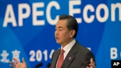 Chinese Foreign Minister Wang Yi gestures during a press conference on the Asia-Pacific Economic Cooperation (APEC) related meetings at the China National Convention Center in Beijing, China, Saturday, Nov. 8, 2014.