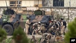 NATO and Afghan troops attend to casualties during a battle with Taliban insurgents who took over a building near the U.S. embassy in Kabul September 14, 2011.