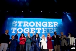 From left, Sen. Cory Booker, D-N.J.; former U.S. Secretary of State Madeleine Albright; actress Debra Messing; Sen. Bob Casey, Jr., D-Pa.; musician Katy Perry; Democratic presidential candidate Hillary Clinton; candidate for U.S. Senate Katie McGinty; candidate for U.S House of Representative; Dwight Evans, Rep. Bob Brady, D-Pa., and television producer Shonda Rhimes appear on stage during a Get Out the Vote concert at the Mann Center for the Performing Arts in Philadelphia, Saturday, Nov. 5, 2016.