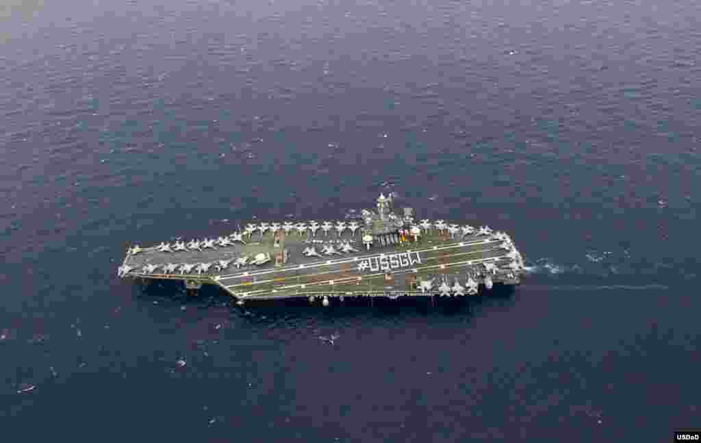 Sailors stationed aboard the U.S. Navy's forward-deployed aircraft carrier USS George Washington (CVN 73) stand in formation to spell out #USSGW on the flight deck. The purpose of the #USSGW photo is to be used on the command's social media websites to broaden its visibility. (U.S. Navy photo by Mass Communication Specialist 2nd Class Trevor Welsh)