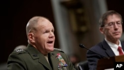 Marine Gen. Robert B. Neller, left, commandant of the Marine Corps, and Acting Navy Secretary Sean J. Stackley, appear before the Senate Armed Services Committee on the investigation of nude photographs of female Marines and other women that were shared on the Facebook page "Marines United," on Capitol Hill in Washington, March, 14, 2017.