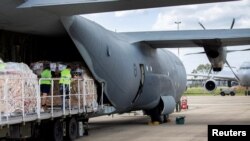 FILE - Australian Air Force Air Movement Operators from No. 23 Squadron load humanitarian assistance and supplies onboard an aircraft bound for Tonga to assist in relief efforts, at RAAF Base Amberley, Queensland, Australia, Jan. 21, 2022.