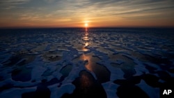 FILE - The sun shines across sea ice in the Canadian Arctic Archipelago, July 22, 2017. The Biden administration is stepping up work to figure out what to do about the thawing Arctic, which is warming three times faster than the rest of the world.