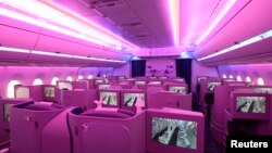The new cabin of an Airbus A350 XWB flight-test aircraft is illuminated during a media-day at the German headquarters of aircraft company Airbus in Hamburg-Finkenwerder, April 7, 2014.