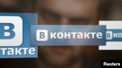 A man looks at a computer screen showing logos of Russian social network VKontakte in an office in Moscow, May 24, 2013. 