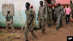 FILE -South Sudanese soldiers accused of a horrific attack on foreign aid workers including rape, torture, killing and looting on the Terrain hotel compound, are assisted to a prison van after attending their trial in Juba, South Sudan.