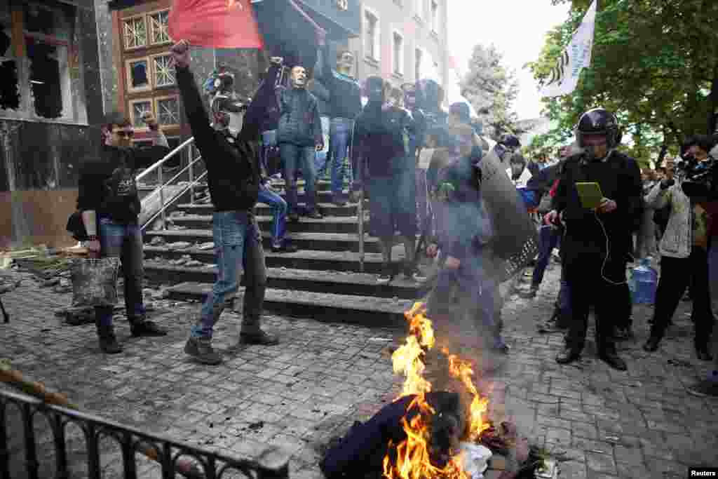 After storming the office, Pro-Russian activists burn uniforms outside the prosecutor's office in the separatist-held city of Donetsk, Ukraine, May 1, 2014.