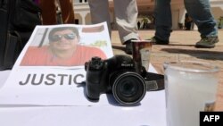 An image of Mexican journalist Jose Guadalupe Chan is seen as his colleagues protest outside the City Hall in Playa del Carmen, Quintana Roo state, Mexico, June 30, 2018. The reporter was fatally shot Friday, the state's prosecutor and the site Chan worked for said.