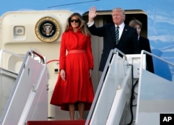 FILE - President Donald Trump waves from Air Force One with First Lady Melania and son Barron.