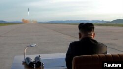 North Korean leader Kim Jong Un watches the launch of a Hwasong-12 missile in this undated photo released by North Korea's Korean Central News Agency, Sept. 16, 2017.