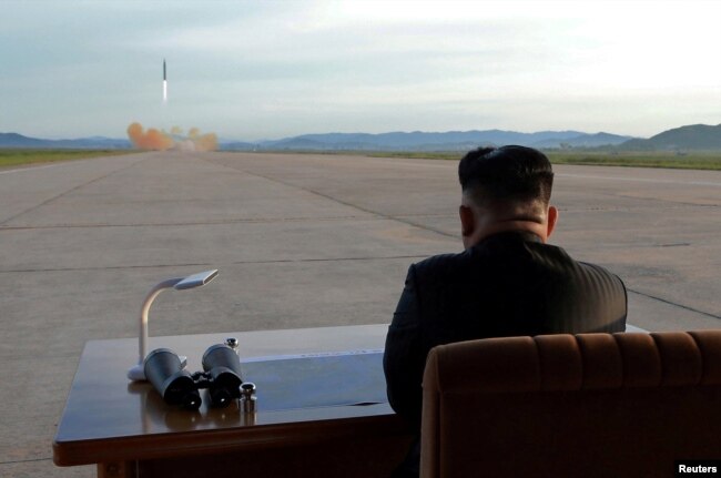 North Korean leader Kim Jong Un watches the launch of a Hwasong-12 missile in this undated photo released by North Korea's Korean Central News Agency, Sept. 16, 2017.