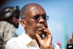FILE -- Haiti's former President Jean-Bertrand Aristide looks on after speaking to supporters at a campaign event for presidential candidate Maryse Narcisse of the Fanmi Lavalas political party, in Port-au-Prince, Haiti.