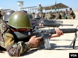 FILE - Afghan soldiers train with their weapons at the Kabul Military Training Center on the outskirts of the Afghan capital.