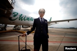 Captain Han Siyuan, 30, poses with Spring Airlines' Airbus A320 after landing at Hongqiao International Airport in Shanghai, China, Oct. 18, 2018.