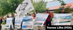Aksi damai Jaringan Advokasi Tambang (Jatam) di depan Kantor Dinas Energ dan Sumber Daya Mineral (ESDM) Sulawesi Tengah mengkampanyekan penghentian pencemaran Danau Tiu di Morowali Utara, Senin, 29 Juli 2019. (Foto: Yoanes Litha/VOA)